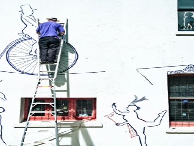 Skilled professional painters working on interior and exterior painting projects with ladder and equipment
